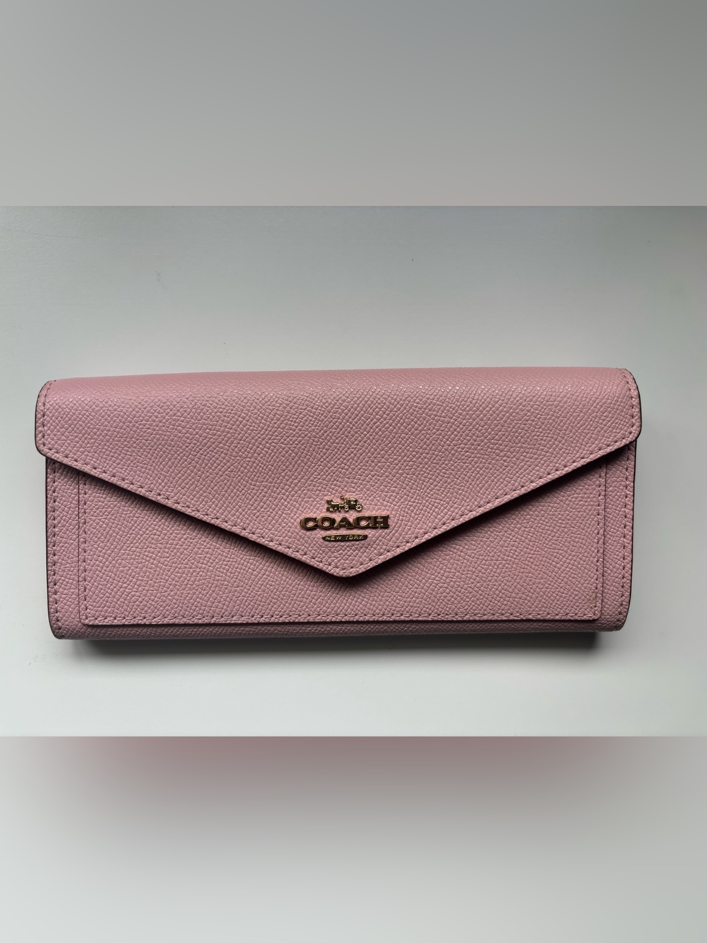 Coach light pink large envelope wallet with gold toned hardware